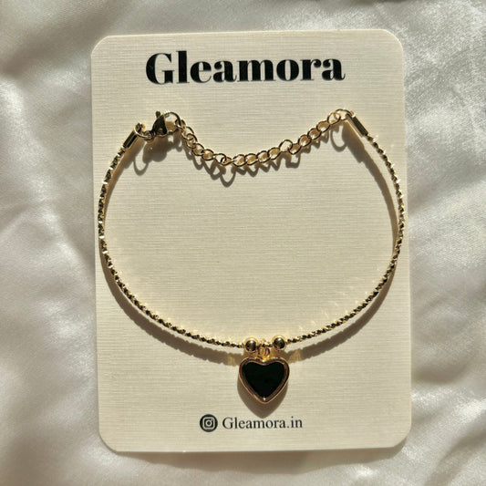 Gold bracelet with a heart-shaped pendant